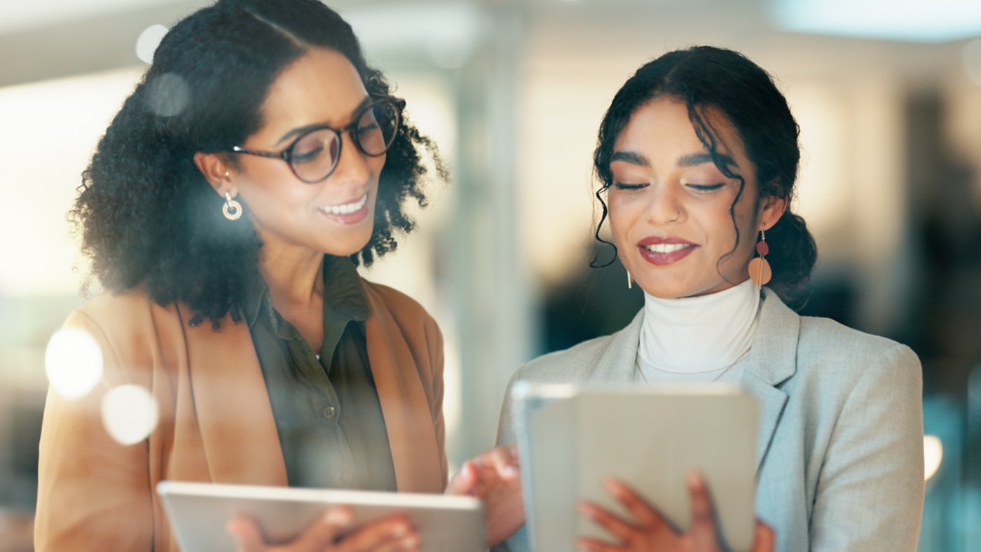 Business, smile and women with a tablet, internet and email notification with social media, typing and productivity. Happy people, consultant and manager with tech, website info and search internet - 16x9