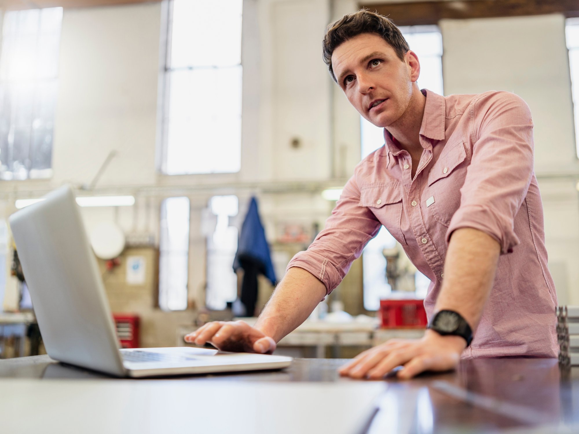 Man using laptop in factory