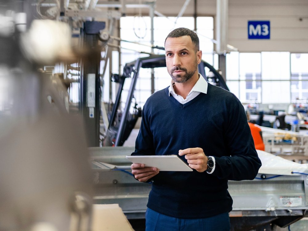 Businessman using tablet in a factory