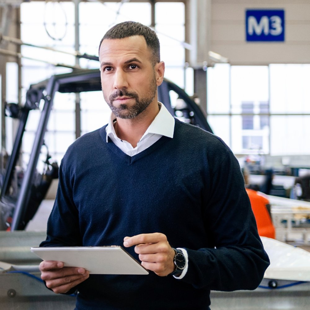 Businessman using tablet in a factory