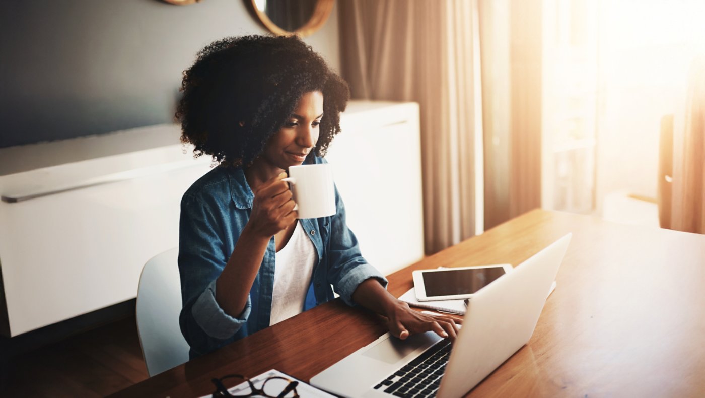 Coffee, laptop and remote work with woman in home office for small business or startup administration. Computer, drink and entrepreneur person in apartment to research target audience information 16x9