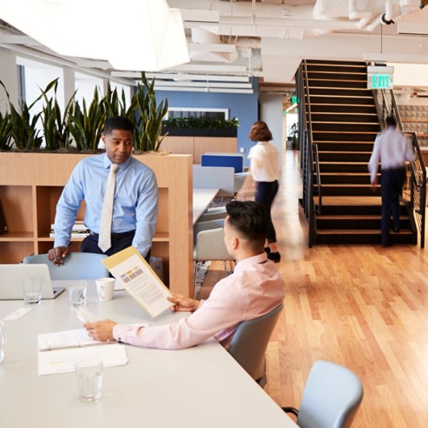 Interior View Of Modern Open Plan Office With Blurred Businessmen And Businesswomen