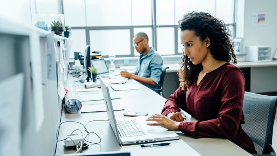 Businesswoman using laptop in office