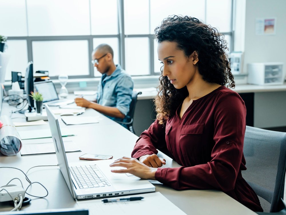 Businesswoman using laptop in office