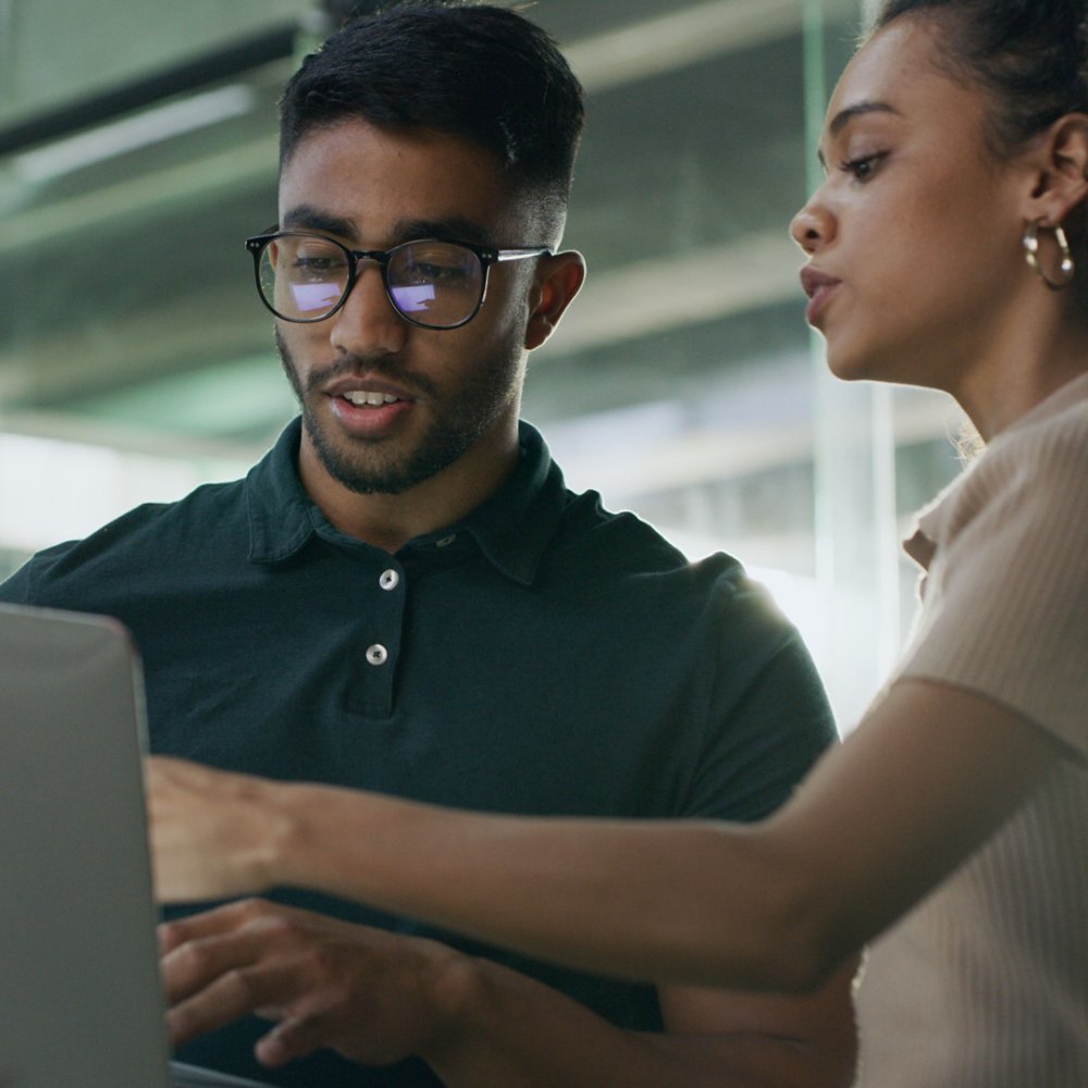 Laptop, meeting and web developers in office with troubleshooting online problem. Computer, conversation and IT professionals with technology for website crash, mistake or error in workplace