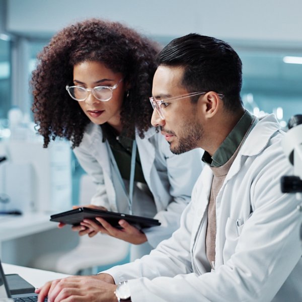 Science, teamwork and scientist with tablet in laboratory for communication, pharmaceutical review or planning. Employees, collaboration and technology for research, discussion and digital analysis.