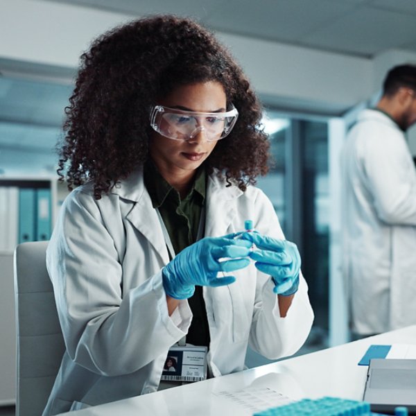 Woman, scientist or blood vial for exam in laboratory, healthcare or pathology to label on test tube. Biotechnology, pharmaceutical and laptop by doctor and online scientific results in phlebotomy.