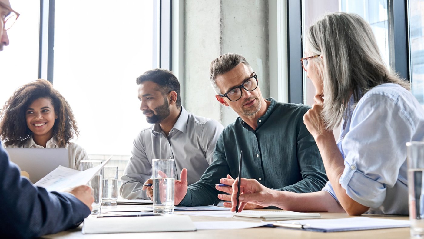 Diverse business people partners group negotiating at boardroom meeting.Multiethnic executive team discussing financial partnership agreement project strategy brainstorming sitting at table in office.