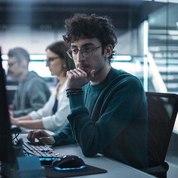 Young Handsome Software Developer Working on Computer in a Technological Laboratory Environment. IT Programming Department Tirelessly Researching and Developing Advanced Commercial Internet Products