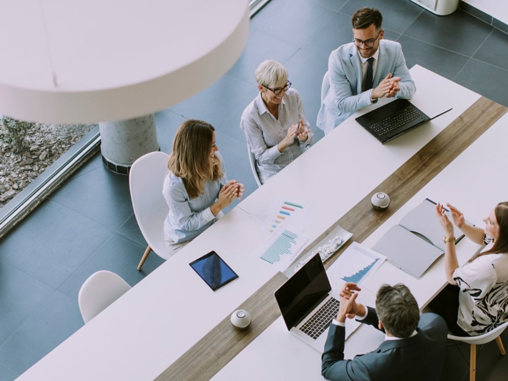 Aerial view at group of business people working together and preparing new project on a meeting in the office