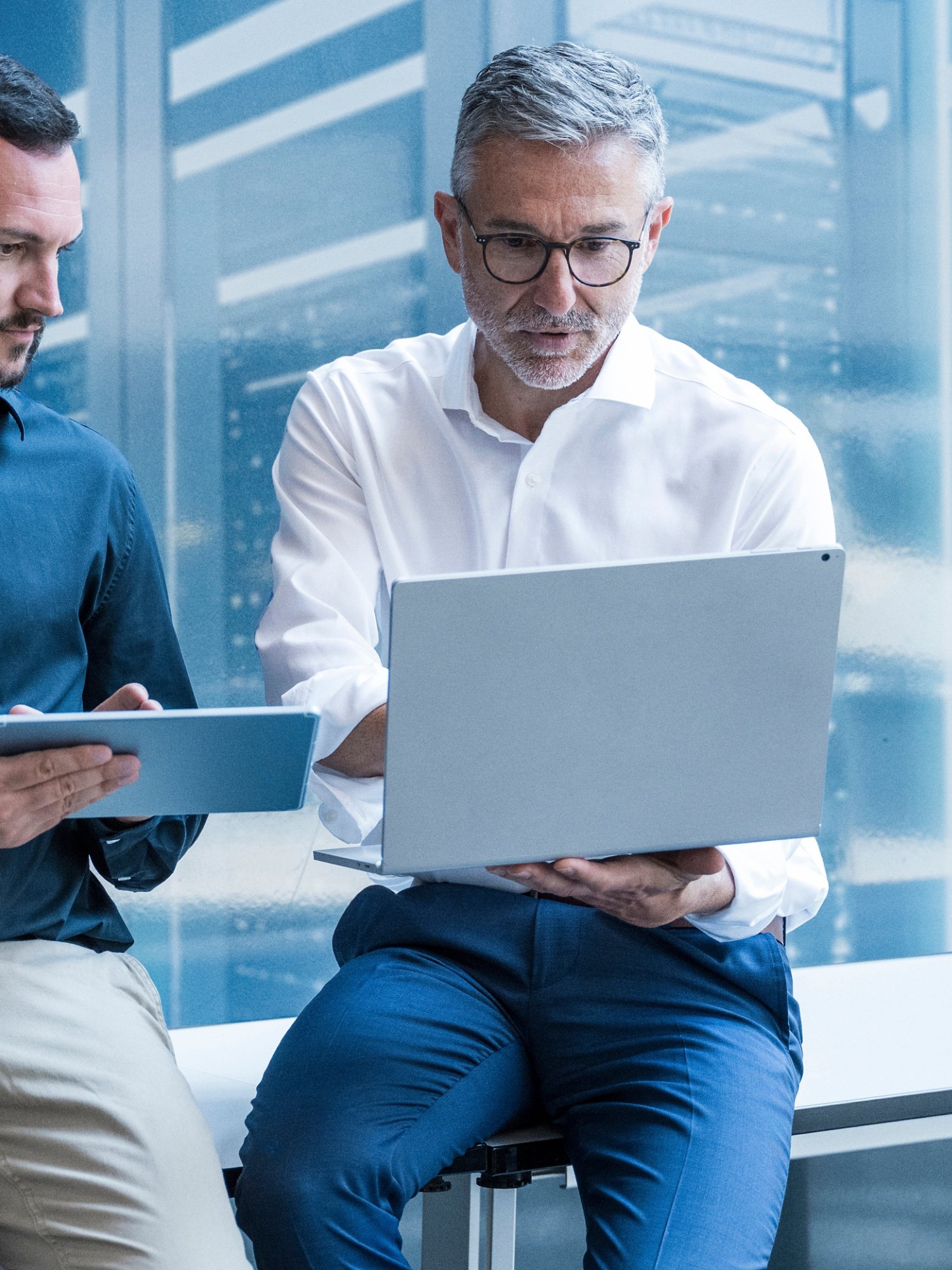 Business team collaborating on digital data analysis in modern office