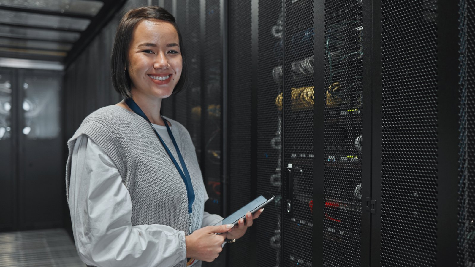 Asian woman, portrait and tablet of technician by server for networking, maintenance or systems at office. Happy female engineer smile for cable service, power or data administration or management.
