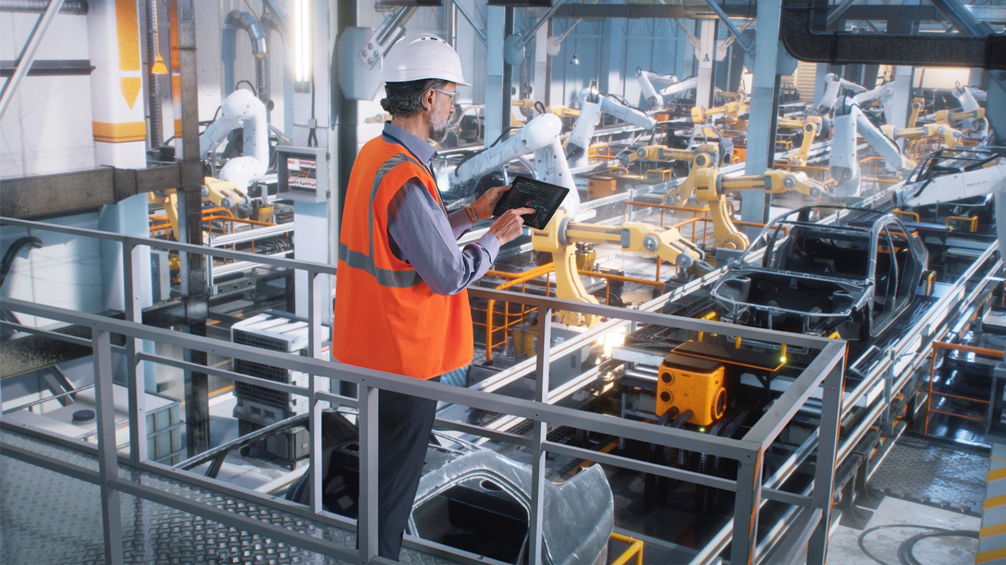 assembly line worker with tablet with orange vest