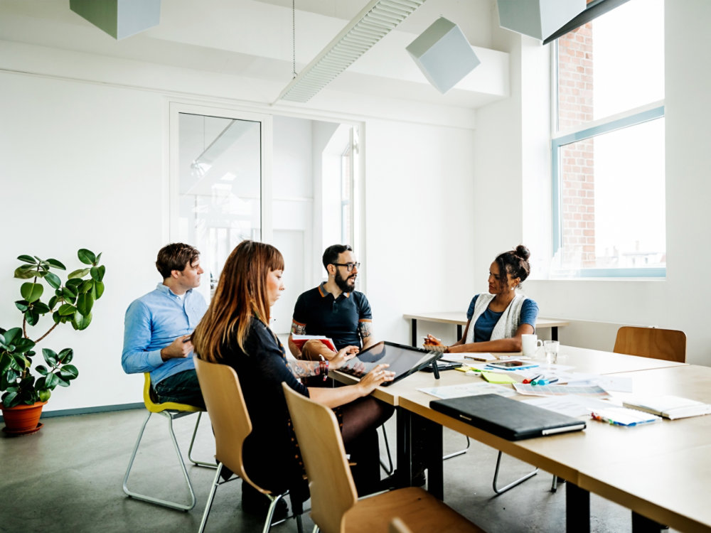 Group of new business people having a meeting in modern office discussing their latest project