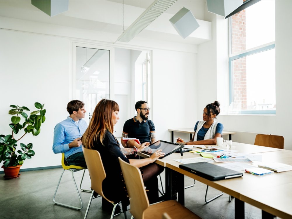 Group of new business people having a meeting in modern office discussing their latest project