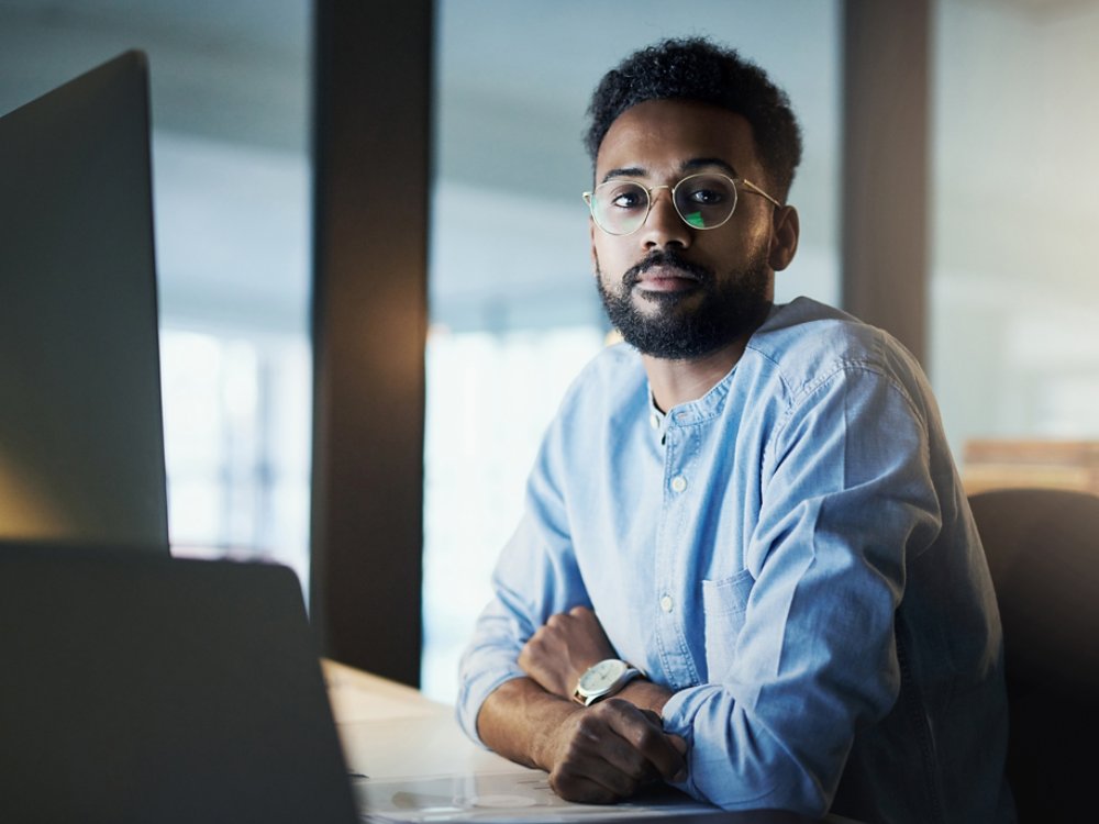 Portrait of a young businessman working in an office at night