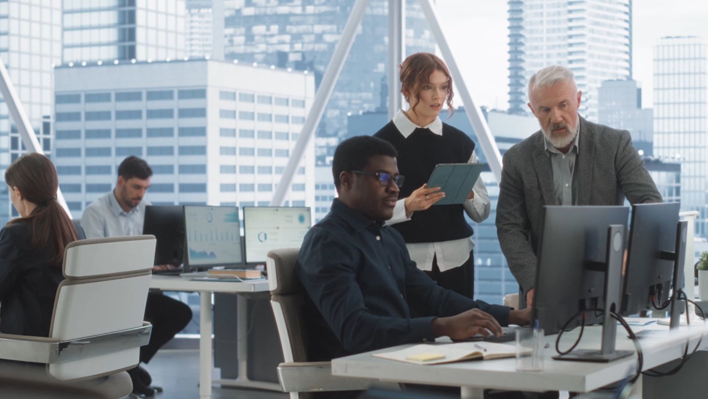 Three people working in an office to solve a problem