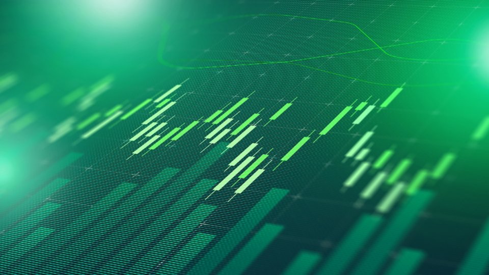 Digital display shows stock market trends with green bars and lines representing data points.