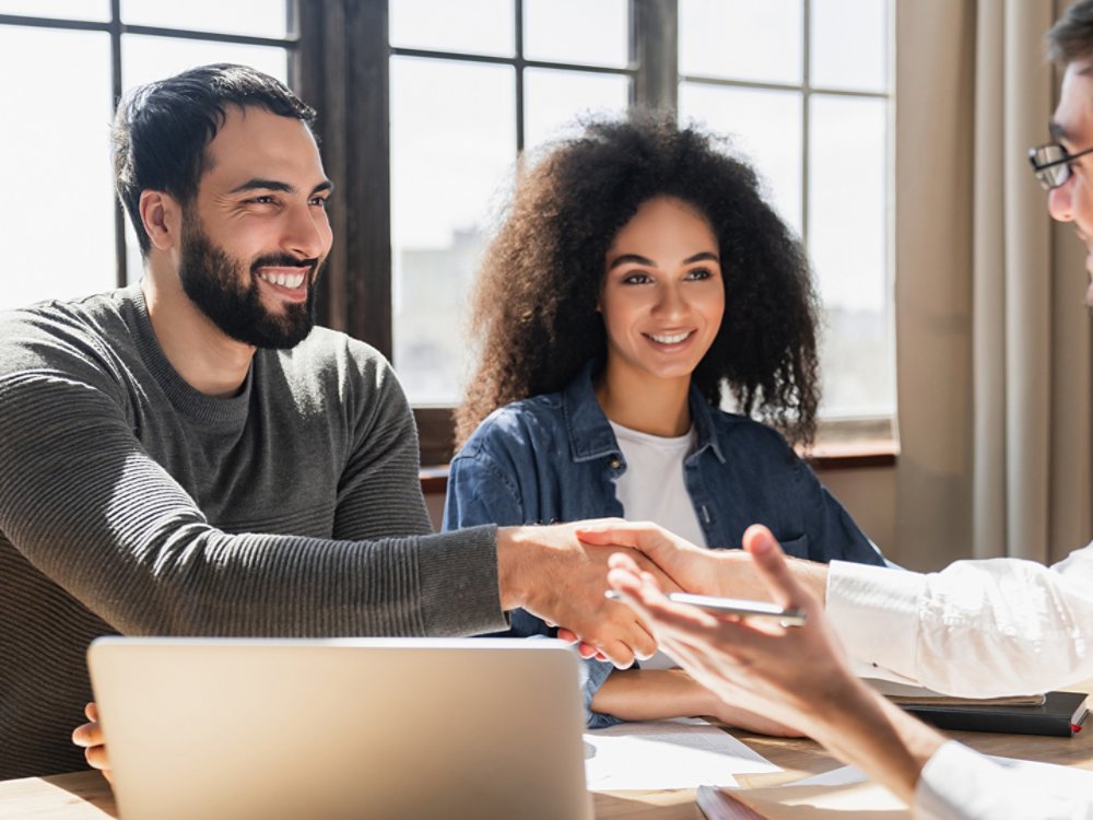 Couple handshake mortgage officer worker, accept bank loan terms and rates feel satisfied. Make financial deal, take credit, buying insurance cover, receive professional consult, sign contract concept