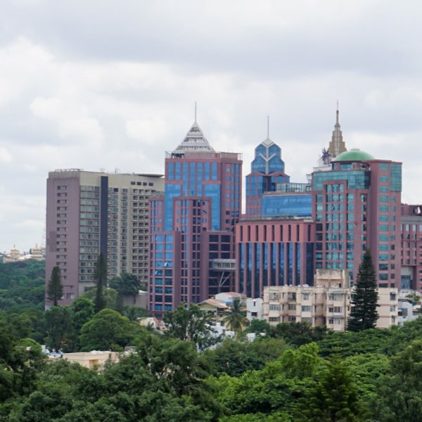 Bangalore,Karnataka,India-June 19 2022: View of Bangalore cityscape from terrace of Chancery Pavilion Hotel. Stadium and skyscrapers such as Prestige UB City Concorde Block visible through green cover.