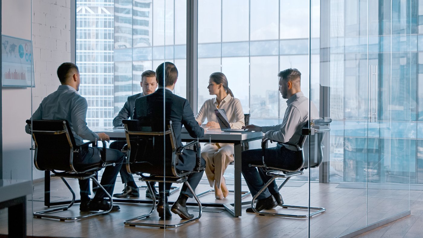 Young business people attending the meeting in boardroom in business district