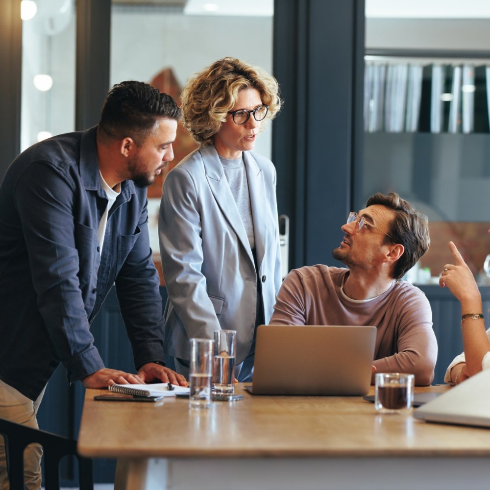 Business people having a meeting in a digital marketing agency. Group of business professionals discussing a project in an office. Teamwork and collaboration in a creative workplace.