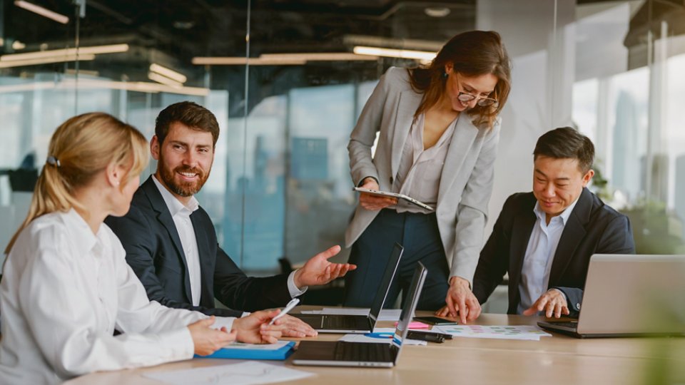 An engaging and dynamic team meeting takes place, emphasizing collaboration and innovation in a modern, sleek office