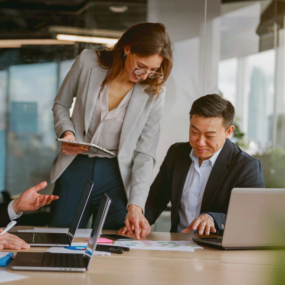 An engaging and dynamic team meeting takes place, emphasizing collaboration and innovation in a modern, sleek office