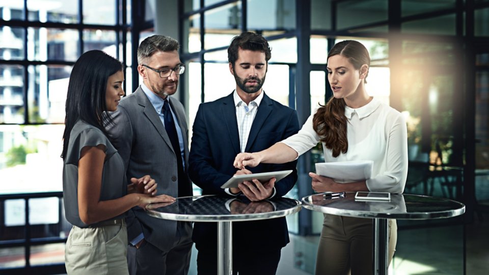 Business people, meeting and discussion with tablet in office for legal advice, planning or report. Lawyer, teamwork and employees with tech at law firm for court case, review or feedback of evidence.