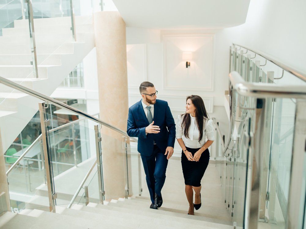 Side view of business people climbing a stair in a building on a morning. Concept of business person's routine. Toned image. Mock up