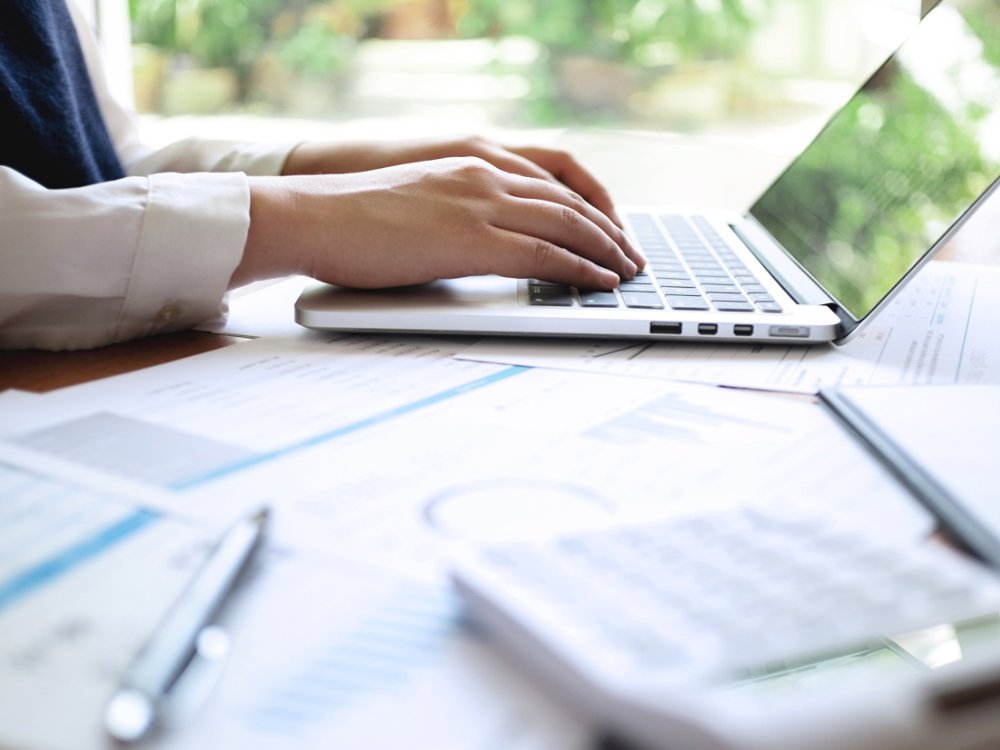Accountant working with data documents calculating on business report. 