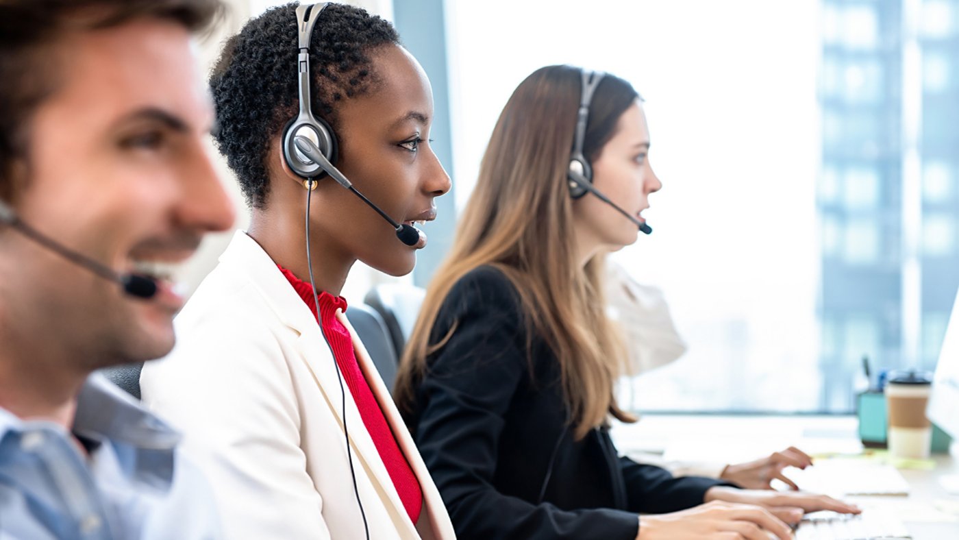 Group of diverse telemarketing customer service staff team working in call center office