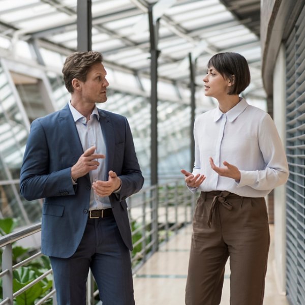 Businessman and woman talking in sustainable office building