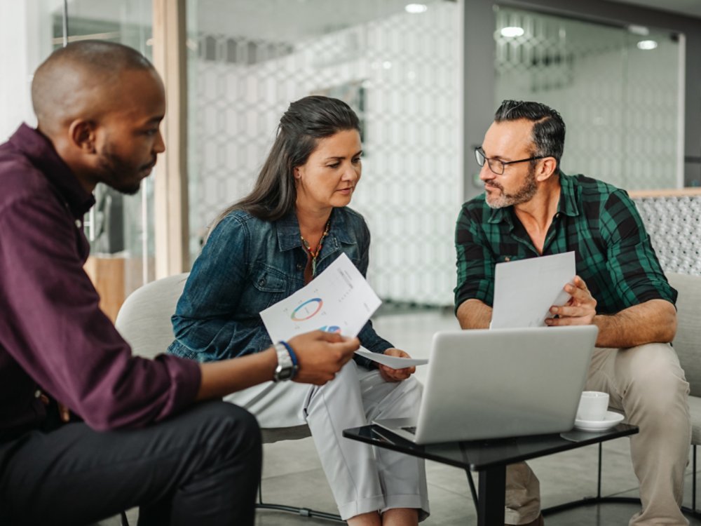 Casual meeting of diverse business team analyzing financial data
