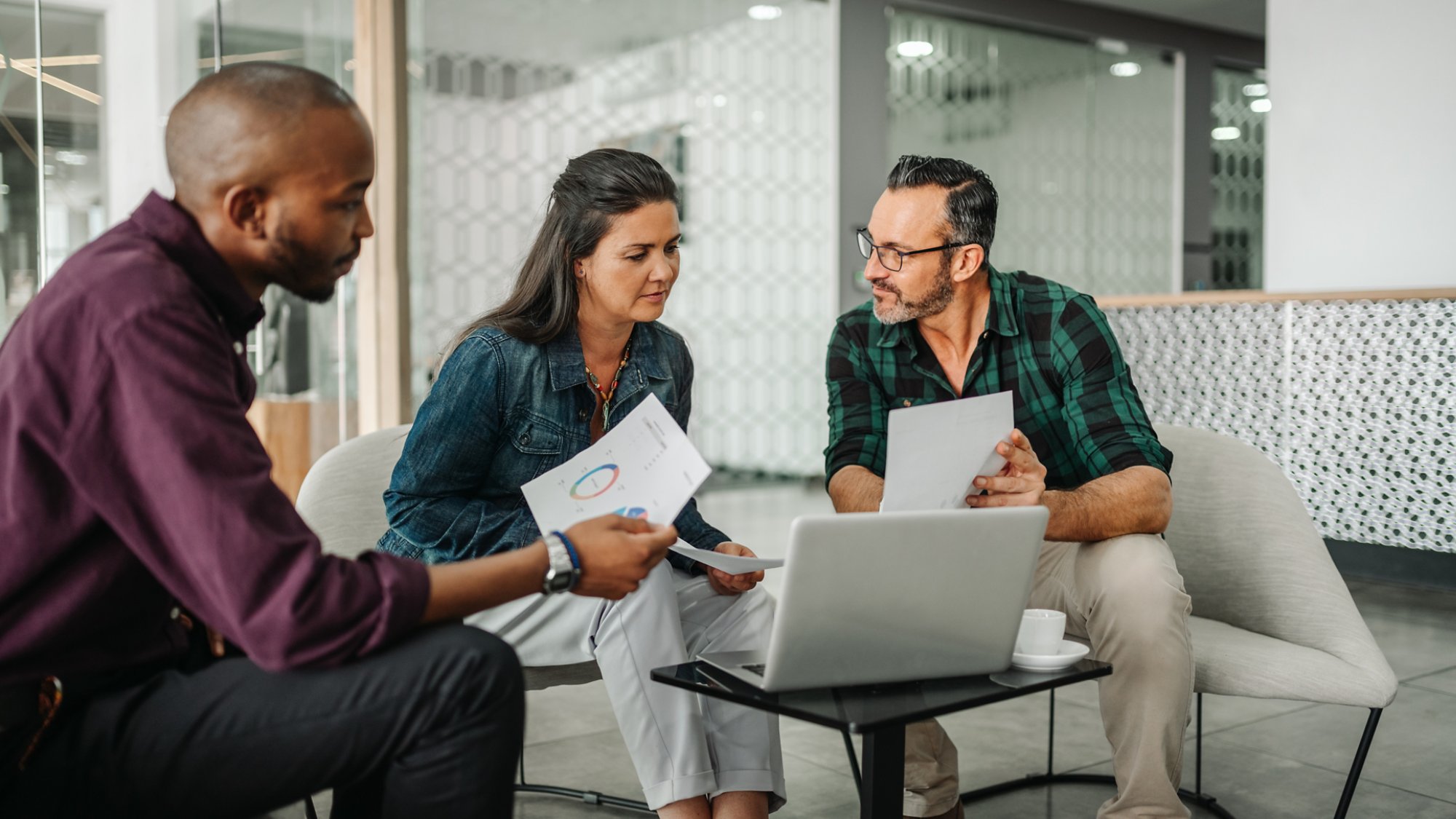 Casual meeting of diverse business team analyzing financial data