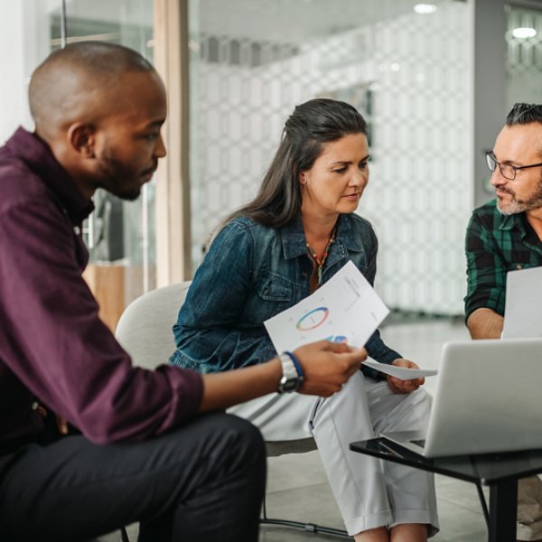 Casual meeting of diverse business team analyzing financial data