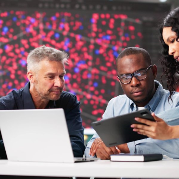 Diverse Cyber Security Team Monitoring Data In Professional Office Setting.