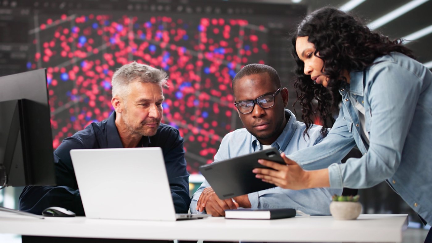 Diverse Cyber Security Team Monitoring Data In Professional Office Setting.