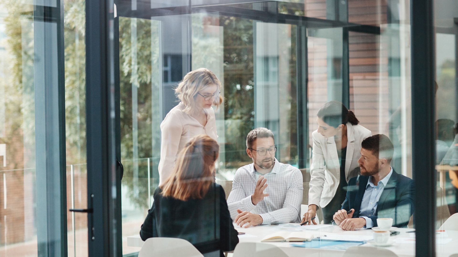 Window, business people or planning in meeting for paperwork, teamwork or collaboration together. Shareholders, investor or executive director speaking in discussion for feedback, review or project.