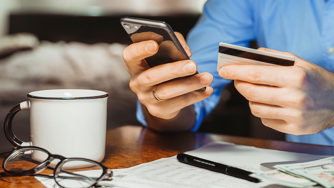 Man holding phone and credit card