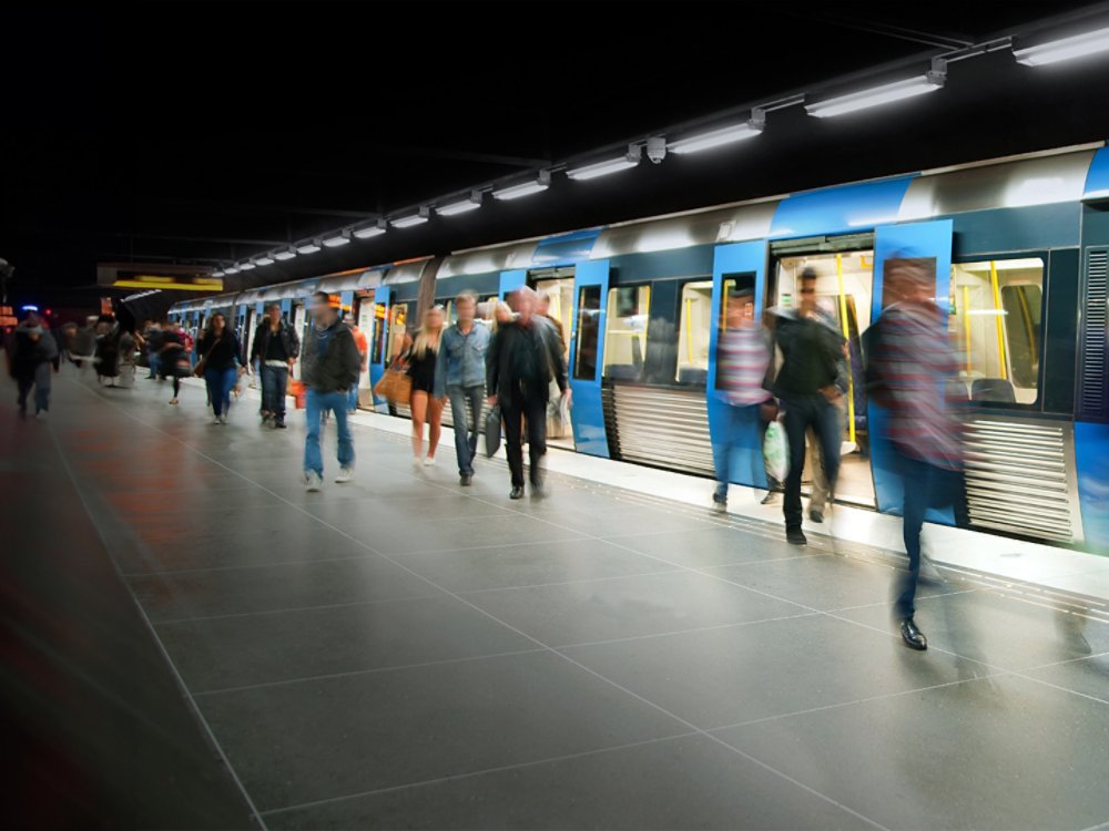 commuters on platform leaving train - blurred motion