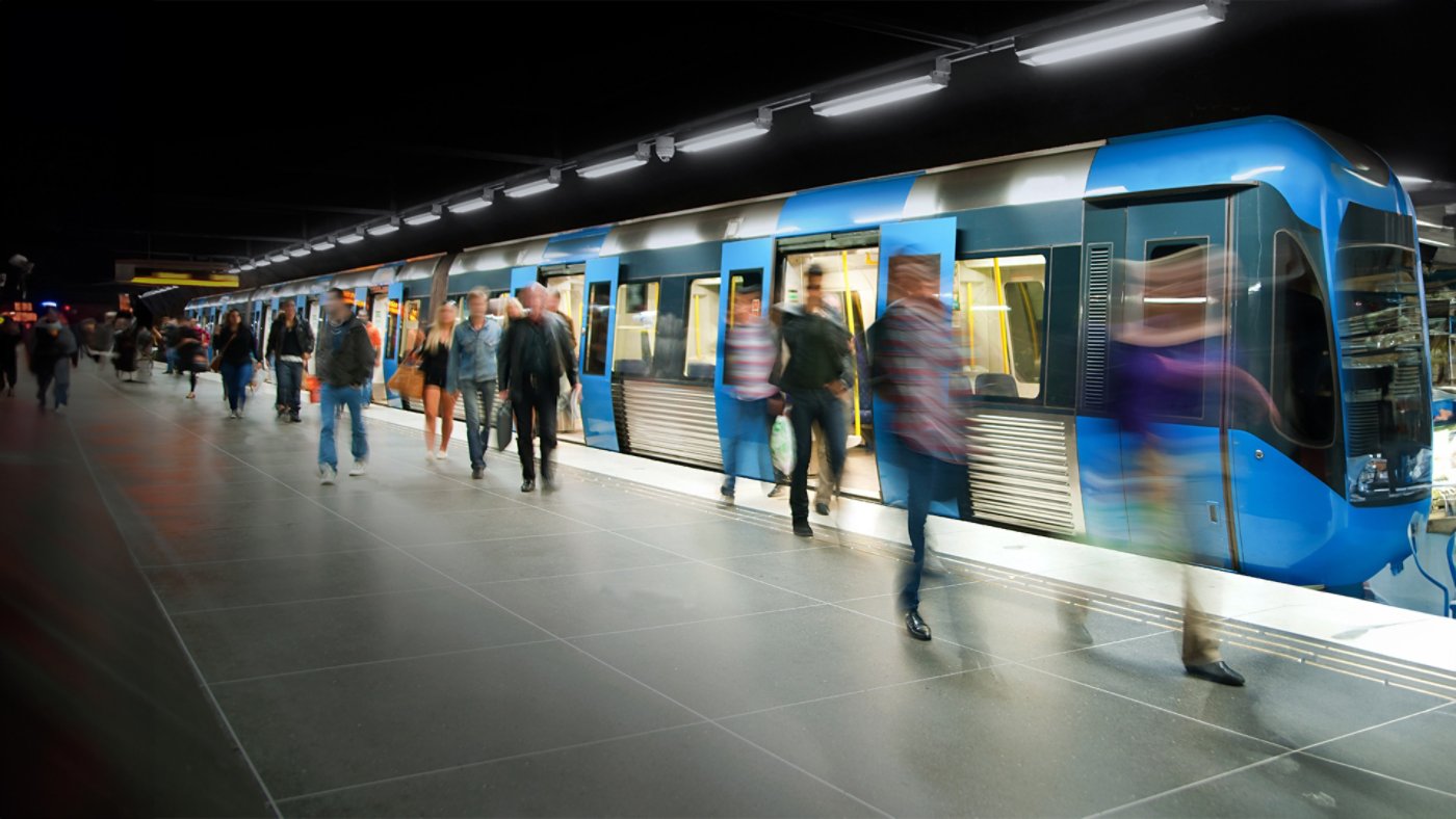 commuters on platform leaving train - blurred motion