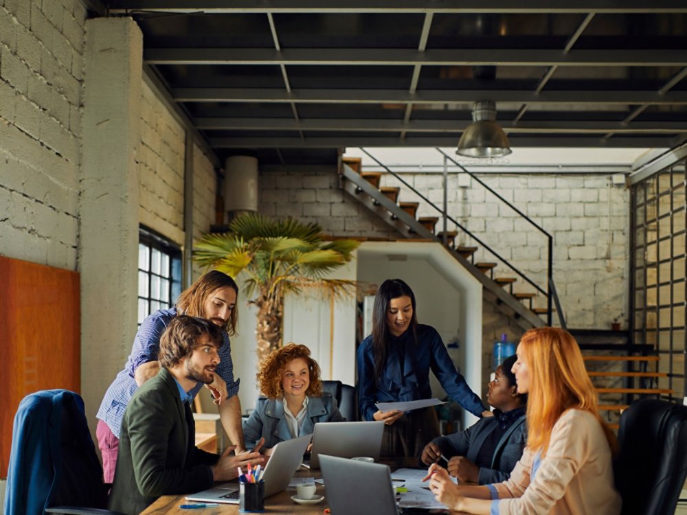 Young and diverse group of designers having a meeting in an office while working in a startup company