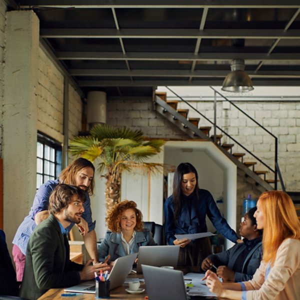 Young and diverse group of designers having a meeting in an office while working in a startup company