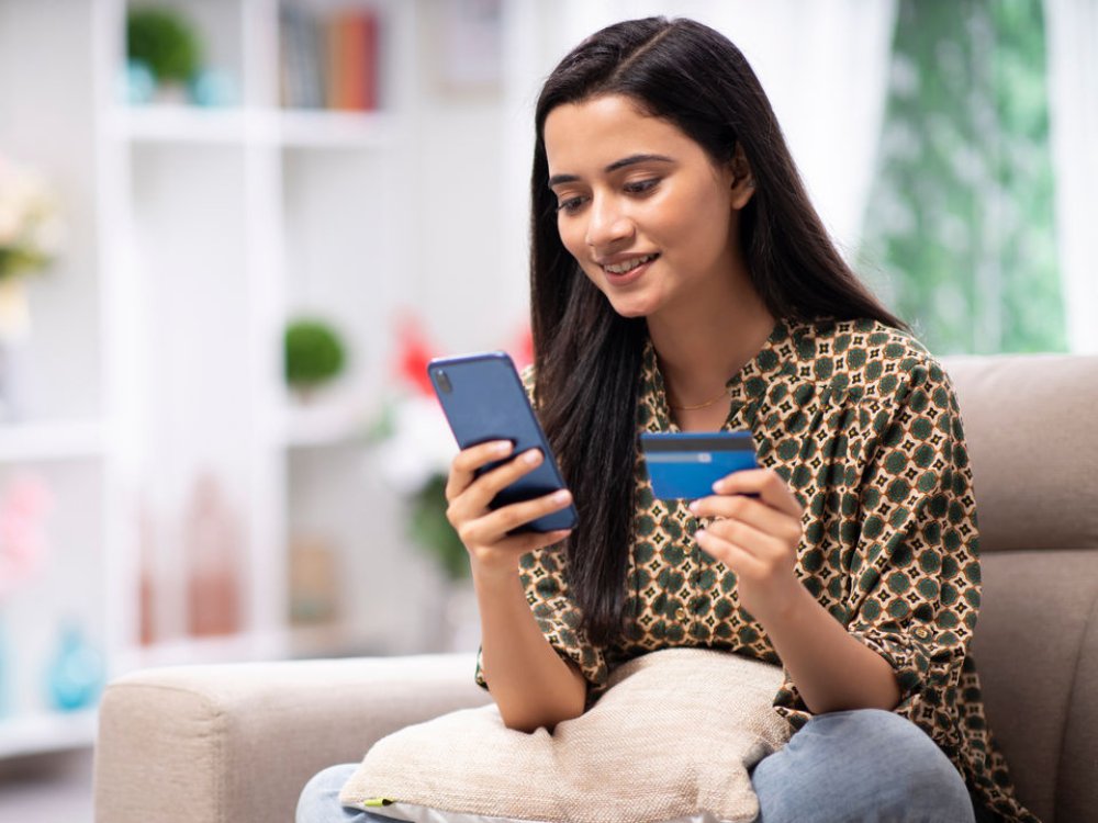 Woman doing a credit card transaction on her phone.