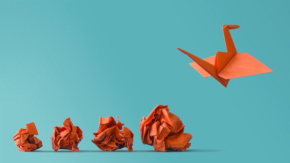 crumpled paper wads with origami swan