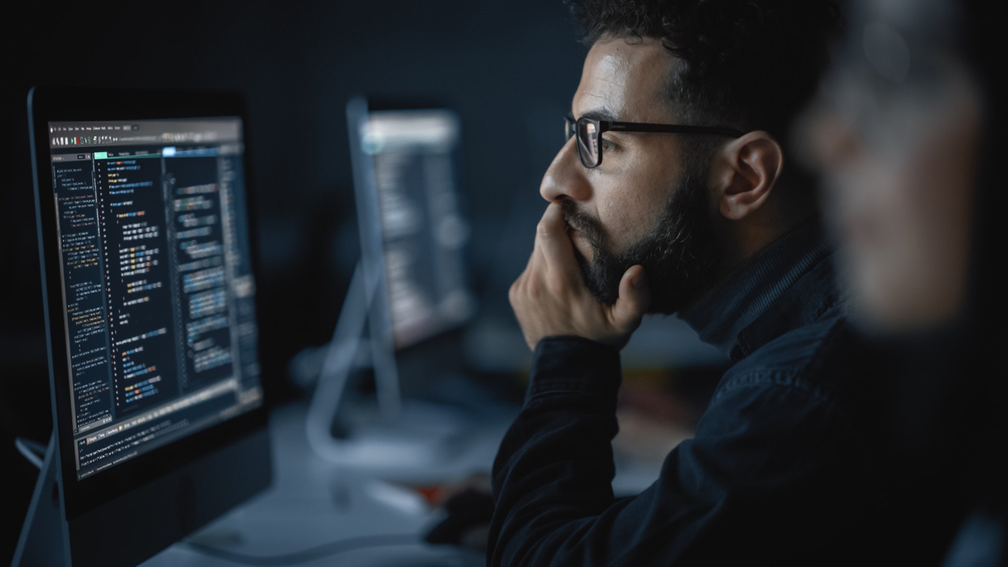 Handsome Smart Male Student, Studying in University with Diverse Multiethnic Classmates. He Works on Desktop Computer in College. Applying His Knowledge in Writing Code, Developing Software.