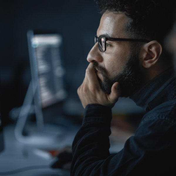 Handsome Smart Male Student, Studying in University with Diverse Multiethnic Classmates. He Works on Desktop Computer in College. Applying His Knowledge in Writing Code, Developing Software.