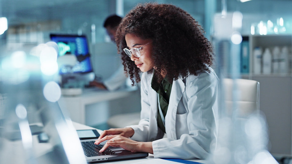 Woman. laptop and lab for research science or online internet for futuristic discovery, microscope or medicine. Female person, brainstorming and biotechnology for investigation, cure or development.