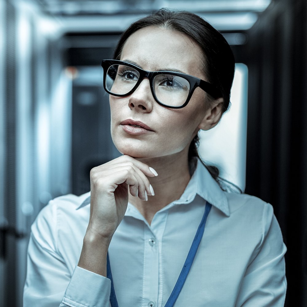 Thinking process. Dark-haired professional from intelligence agency in eyeglasses looking thoughtful while analyzing the details of the case